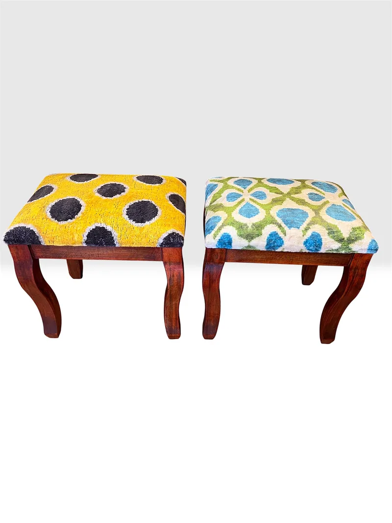 A pair of kilim stools with saffron and garden-lattice tops on walnut frames